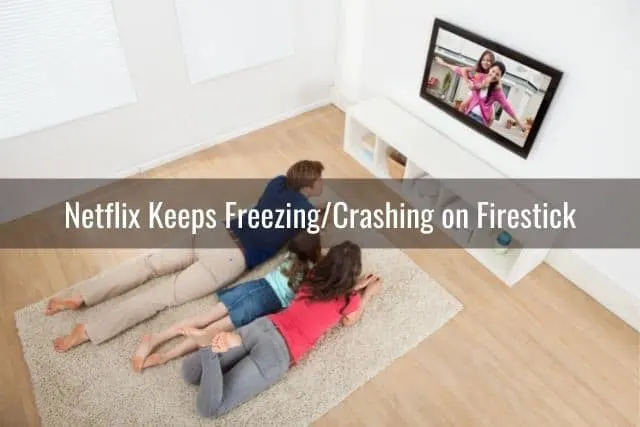 Mom and kids lying on floor watching TV