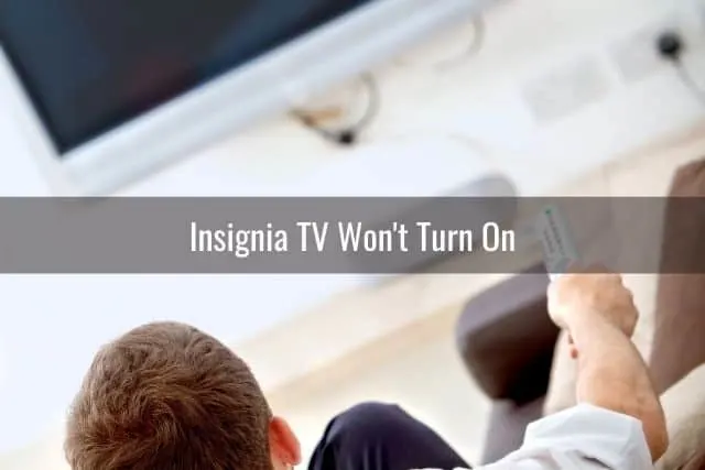 Male sitting in front of TV that is turned off