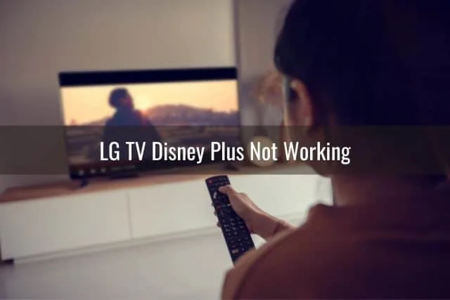 Female watching TV with remote in hand