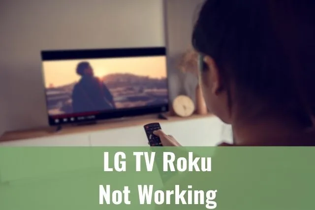 Female adjusting TV remote volume