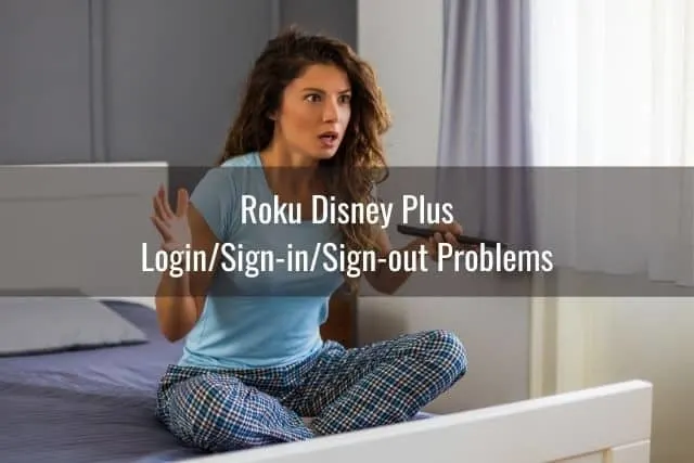 Confused female in sleepwear wondering why TV remote is not working