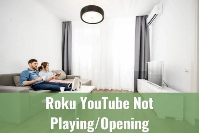 Couple sitting in living room watching TV