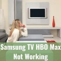 Female sitting on living room floor looking at mounted TV