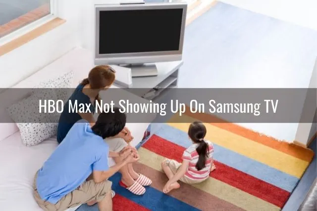Family sitting in living room looking at TV