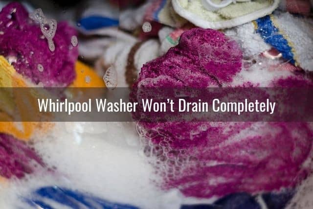 Washing machine tub filled with water and clothes