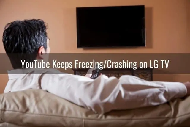 Male sitting on couch watching TV