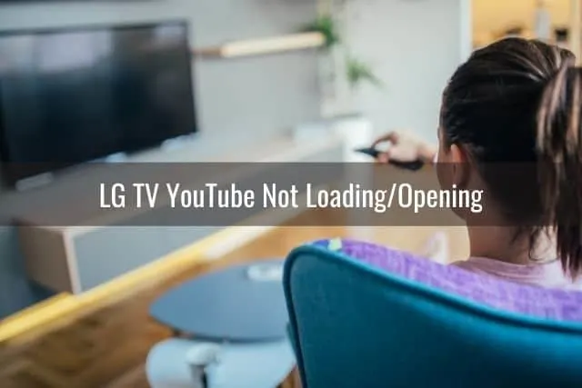 Female using remote to turn on TV