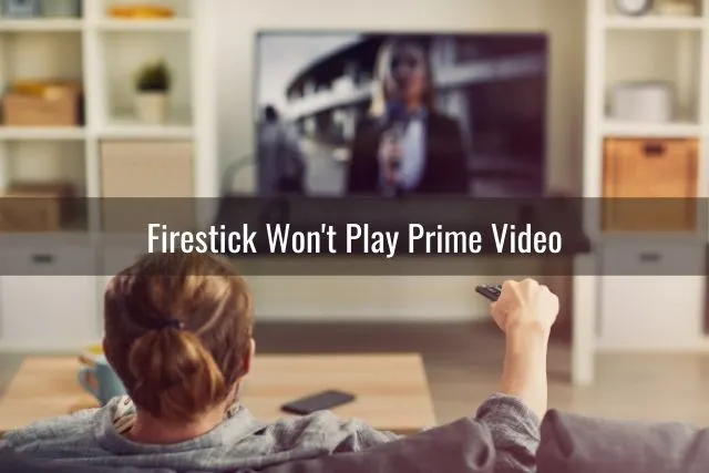 Male on couch using remote to change TV channels