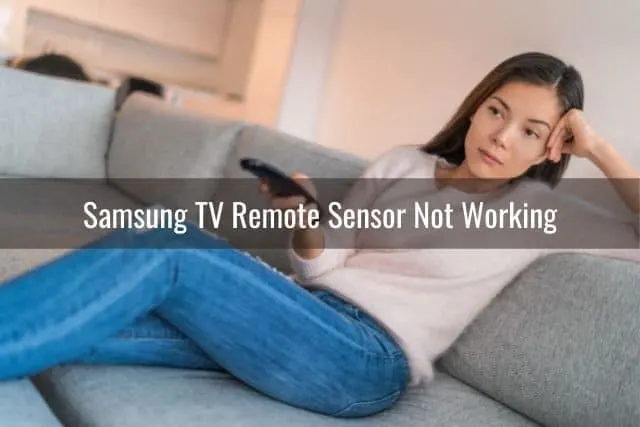 Female relaxing on sofa and changing TV channels