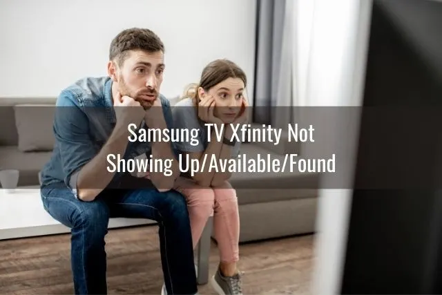 Bored male and female couple sitting on couch waiting for TV to load