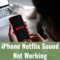 woman holding iphone while watching netflix
