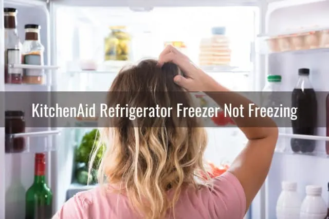 Confused woman looking at the refrigerator