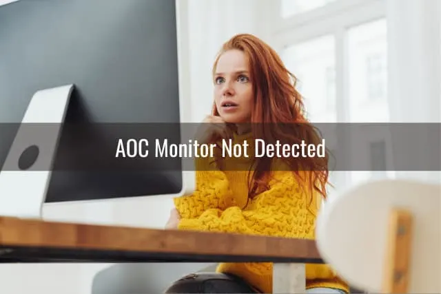 Confused woman while looking at the monitor