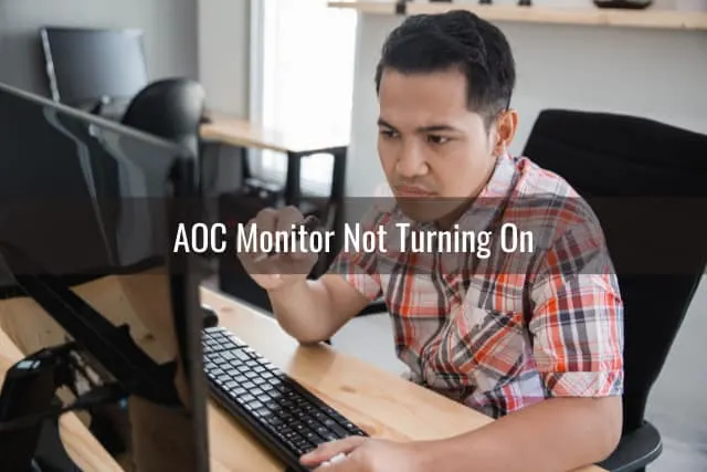 Confused man while looking at the monitor