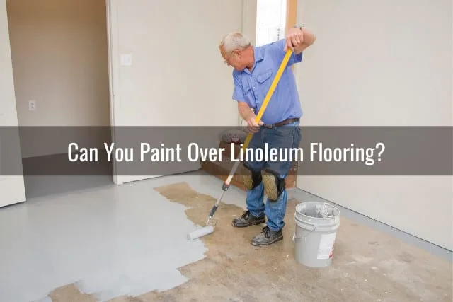 Man painting the floor with white