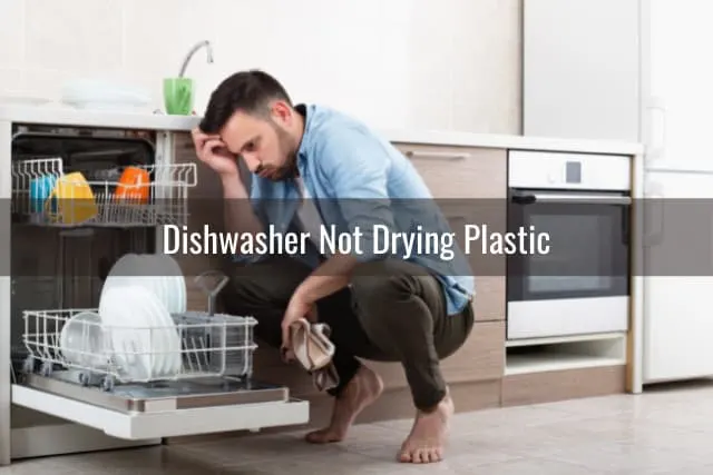 Confused man while looking at the dishwasher