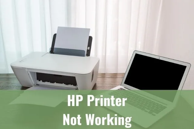 Laptop and printer on wood table