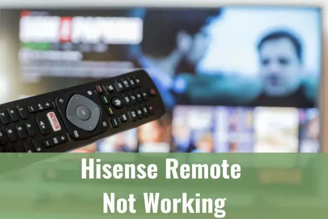 holding a remote while pointing at the TV