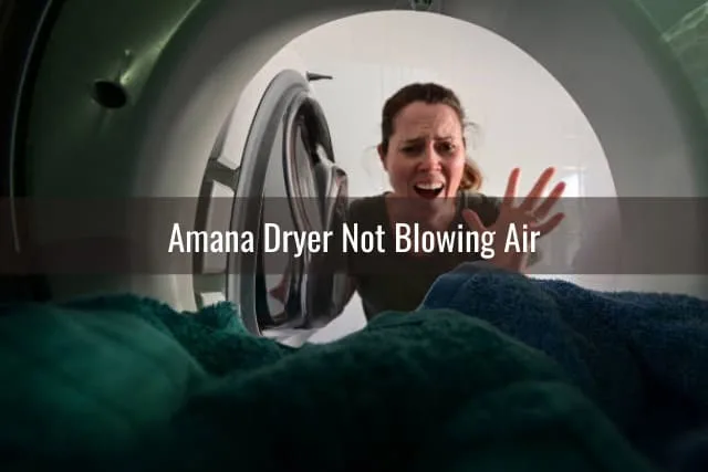 Frustrated woman looking at the dryer
