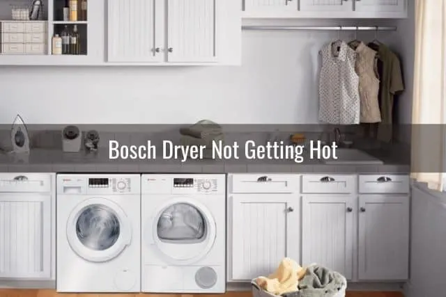 White dryer and washing machine in laundry room