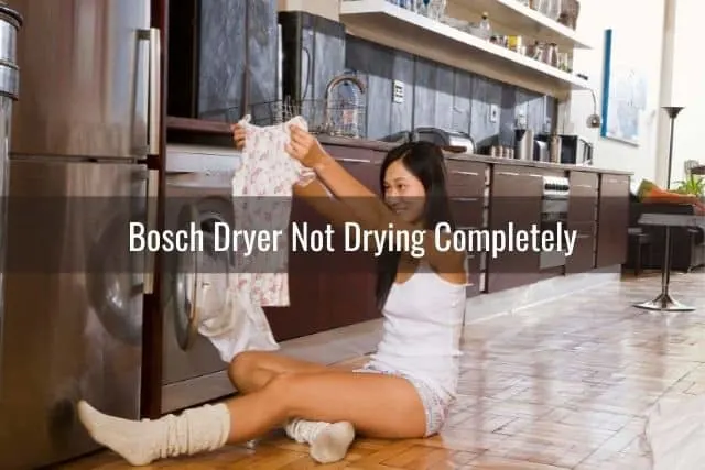 Woman pulling clean laundry out of dryer