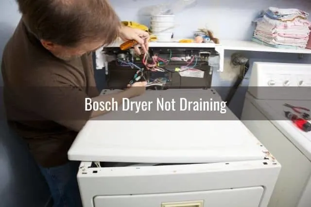 Repair man fixing dryer