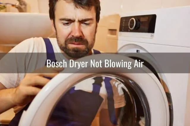 Repair man fixing dryer door