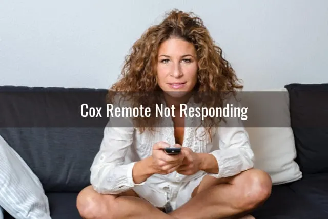 Woman holding a remote while watching tv
