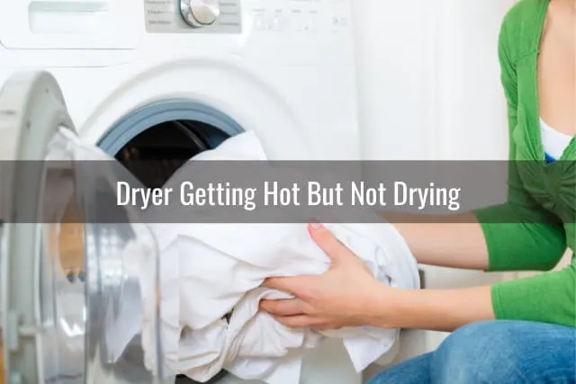 Woman putting clothes in dryer