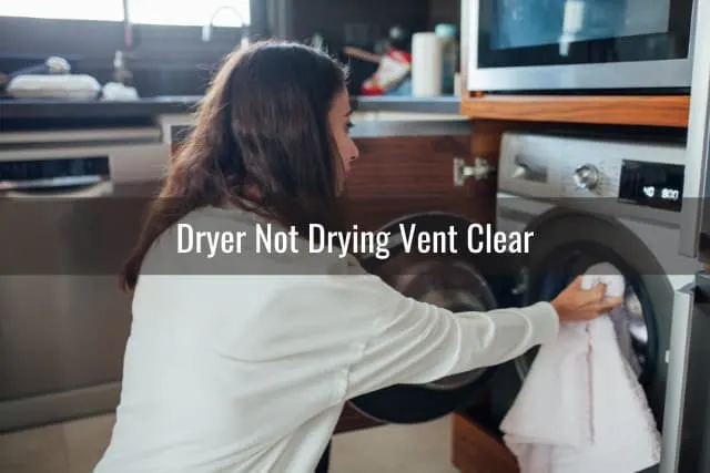 Woman putting clothes in dryer