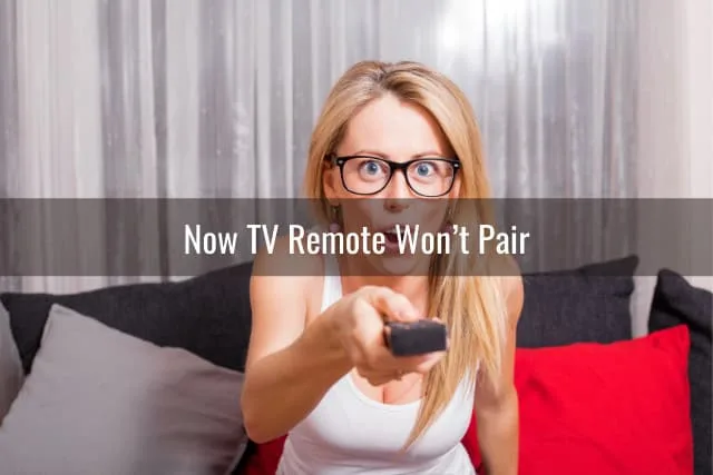 Confused woman while holding a remote
