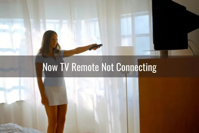 Woman holding a remote while watching tv