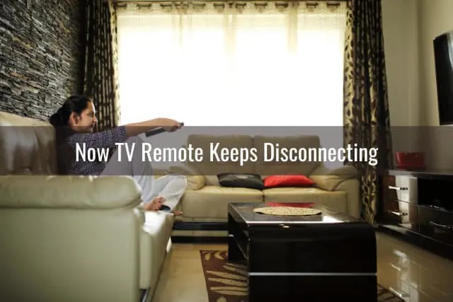 Woman holding a remote while watching tv