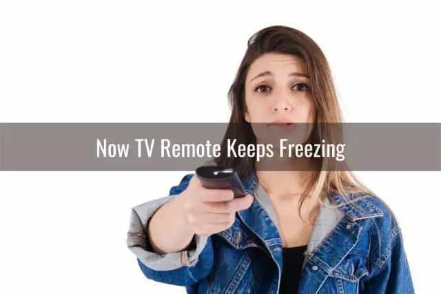 Confused woman while holding a remote