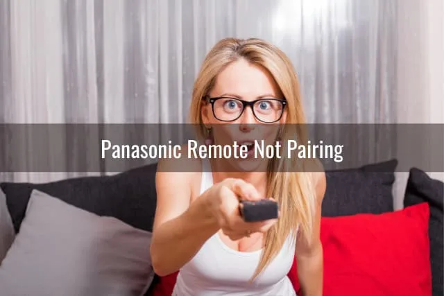Confused woman while holding a remote