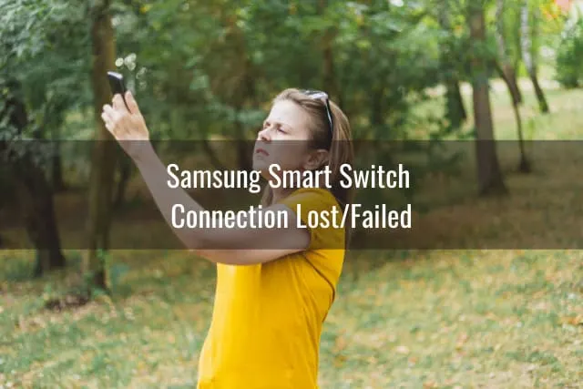 Woman holding a phone while looking for a signal