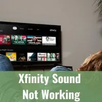 Man watching Tv while laying in a sofa