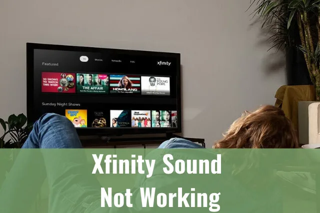 Man watching Tv while laying in a sofa