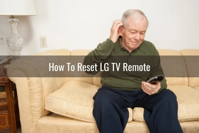 confused man holding a remote while watching tv