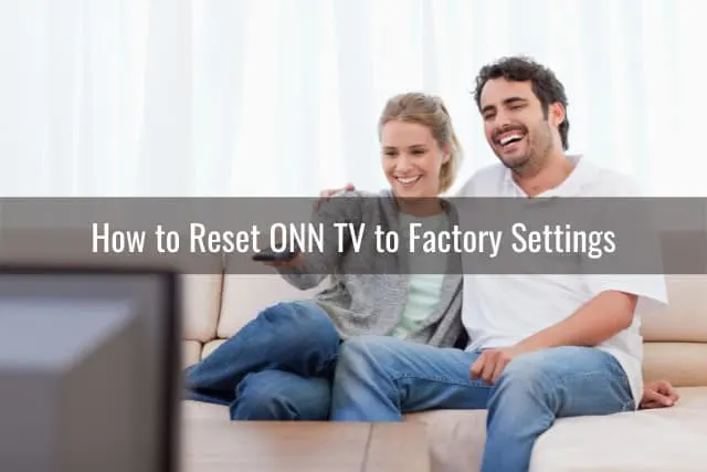 Couple watching TV while sitting on the sofa
