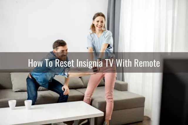 couple holding a remote
