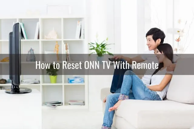 Couple watching TV while sitting on the sofa