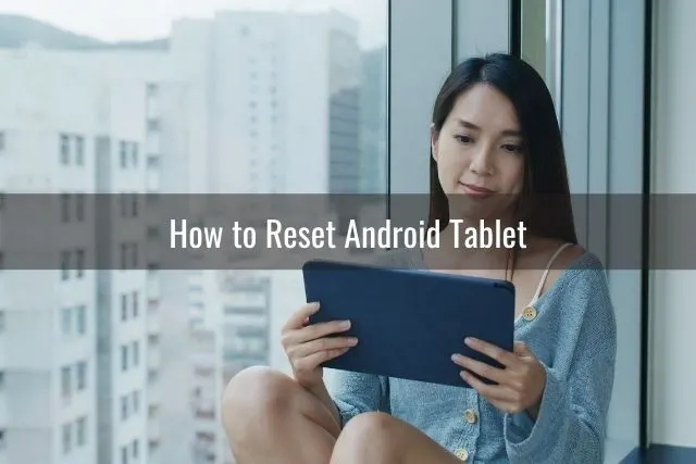 Woman sitting in a high rise apartment using tablet