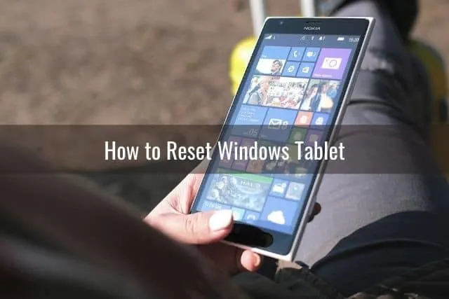 Hand holding a Windows tablet