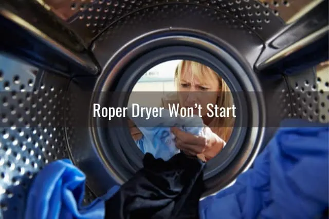 Woman checking the clothes inside the dryer