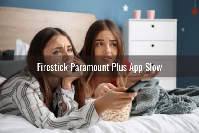 Two teenage girls on bed confused why TV is not working