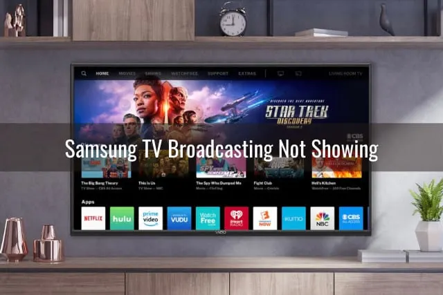Flatscreen tv on the wall and woman holding a phone