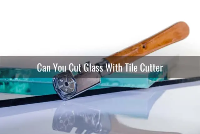 Man cutting the glass using cutter