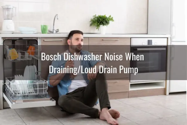 Tired man sitting on the floor behind the dishwasher