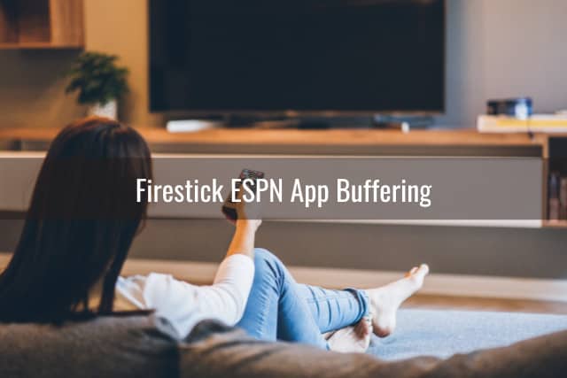 Woman watching tv while holding a remote